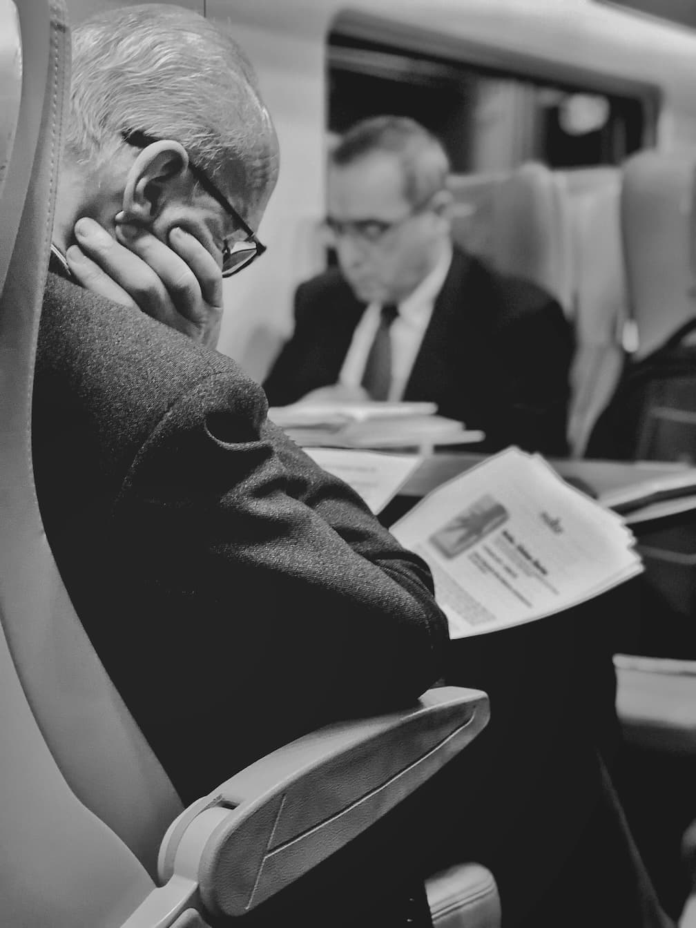 Executives reviewing reports while traveling